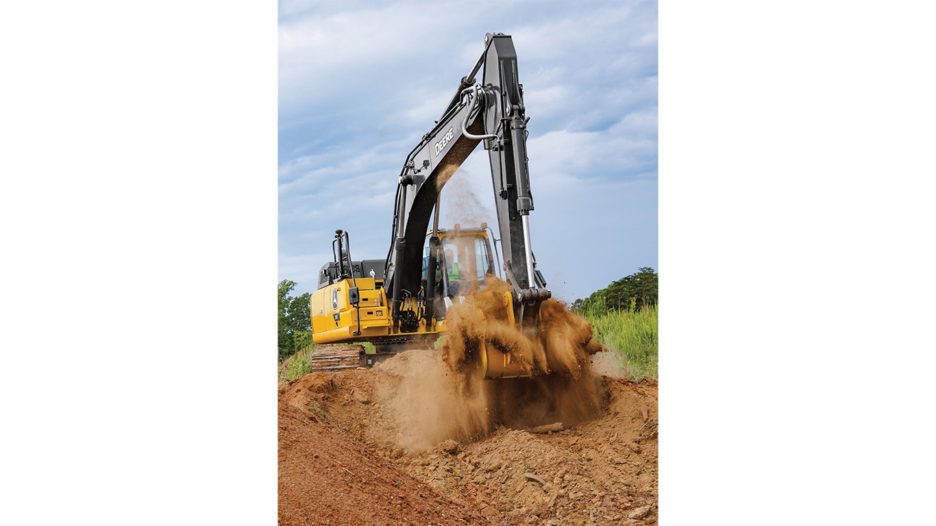 Un operador usa una Excavadora 210P-Tier para mover tierra con un campo verde y árboles en el fondo.