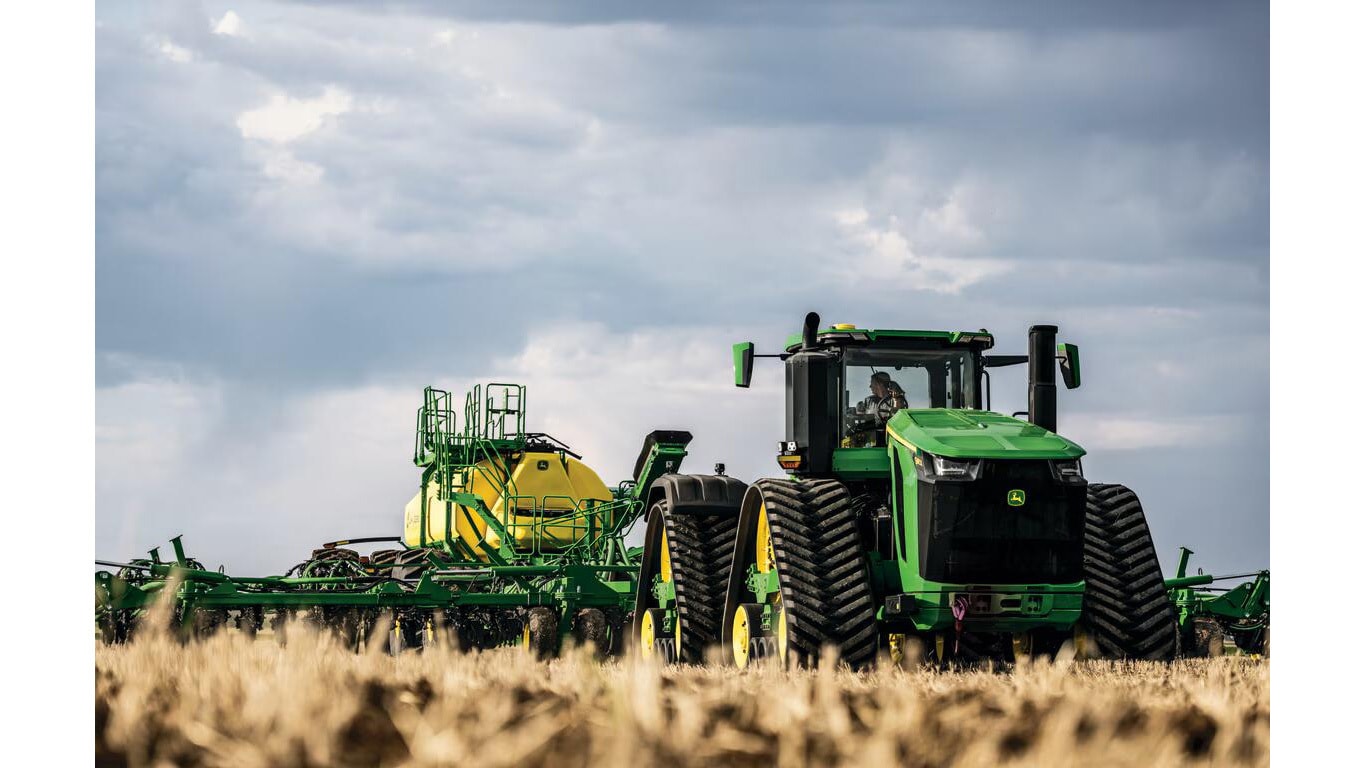Tractor en operación en el campo, equipado con implemento agrícola de gran tamaño.