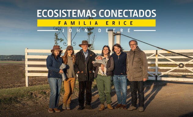 Una familia parada frente a una cerca en su granja. Graphic title: ecosistemas conectados familia erice