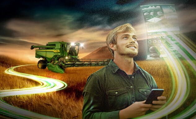 Un hombre con un teléfono móvil en la mano, observando un holograma de las operaciones de campo. Al fondo, una cosechadora S7.