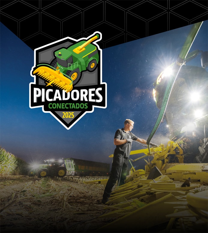Un hombre frente a una máquina John Deere por la noche, debajo de una pancarta negra con el logotipo de Picadores Conectados 2025