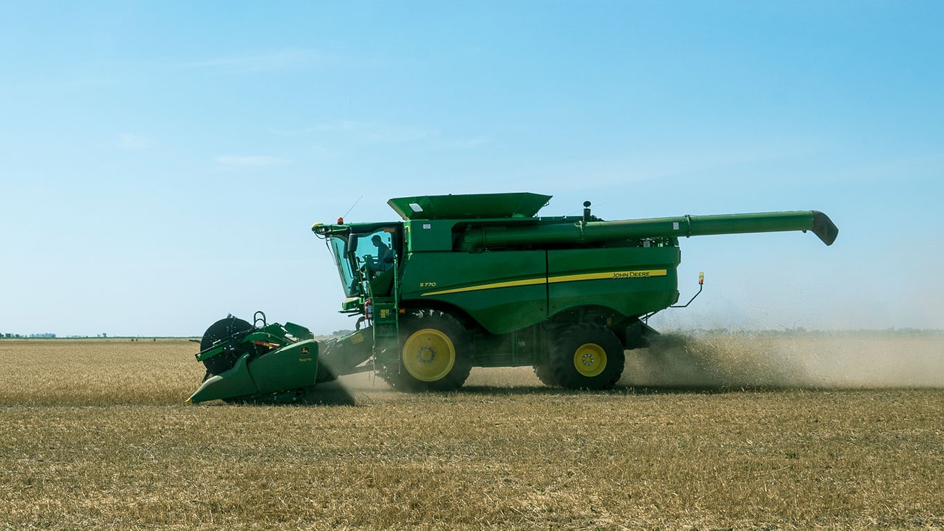 Cosechadora John Deere trabajando en el campo, vista lateral